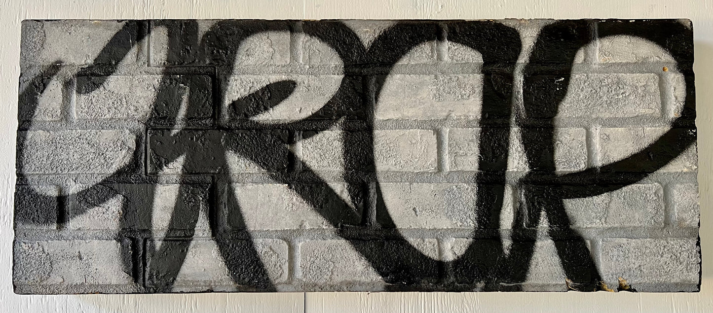 TRAP tag on grey brick